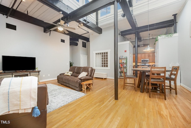 1535 Caraleigh Mills Ct Unit 142, Raleigh, NC 27603 - living area featuring a towering ceiling, wood finished floors, ceiling fan, and beamed ceiling