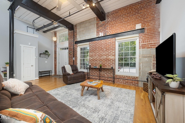 1535 Caraleigh Mills Ct Unit 142, Raleigh, NC 27603 - living room featuring brick wall, wood finished floors, a wood ceiling with exposed beams, and a towering ceiling