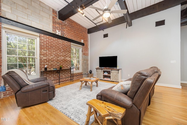 1535 Caraleigh Mills Ct Unit 142, Raleigh, NC 27603 - living room featuring ceiling fan, beamed ceiling, wood finished floors, and brick wall