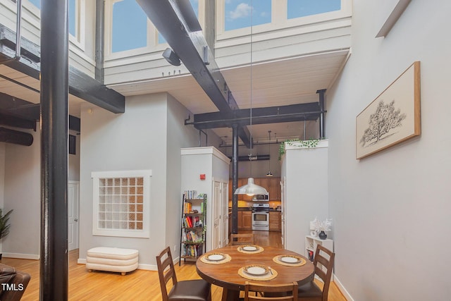 1535 Caraleigh Mills Ct Unit 142, Raleigh, NC 27603 - dining room featuring a towering ceiling, wood finished floors, and beam ceiling