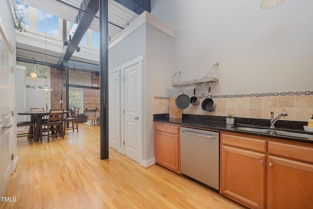 1535 Caraleigh Mills Ct Unit 142, Raleigh, NC 27603 - kitchen with stainless steel dishwasher, light wood finished floors, dark stone countertops, and decorative backsplash