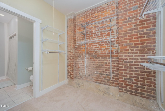 1535 Caraleigh Mills Ct Unit 142, Raleigh, NC 27603 - bathroom with brick wall and tile patterned floors