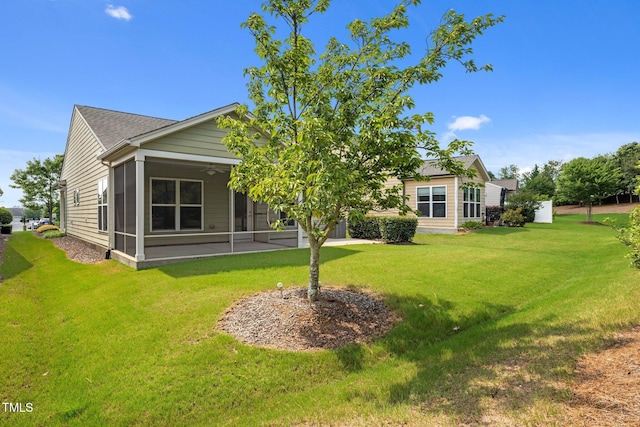 1704 Horne Creek Dr, Durham, NC 27703 - back of property with a lawn, a ceiling fan, and a sunroom