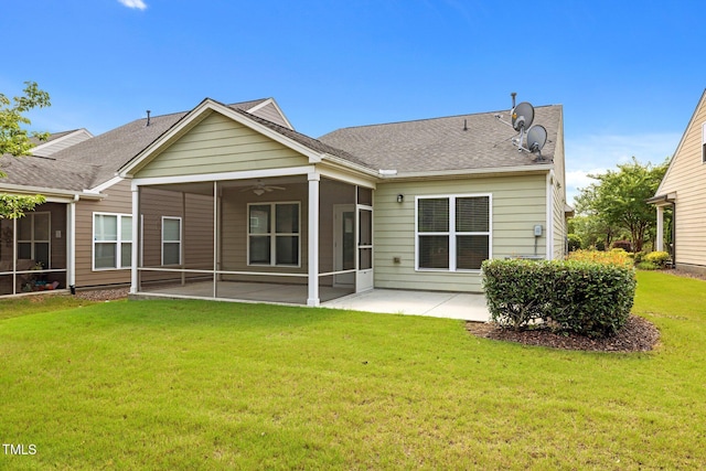 1704 Horne Creek Dr, Durham, NC 27703 - back of property featuring a sunroom, a patio, a yard, and a shingled roof
