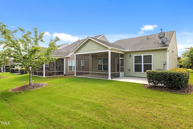 1704 Horne Creek Dr, Durham, NC 27703 - back of property with a sunroom, a lawn, a patio area, and a shingled roof
