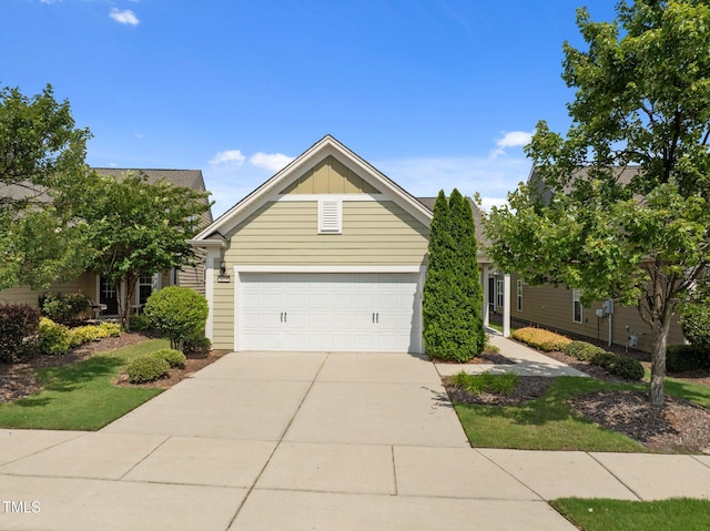 1704 Horne Creek Dr, Durham, NC 27703 - view of front facade with driveway, a garage, and board and batten siding