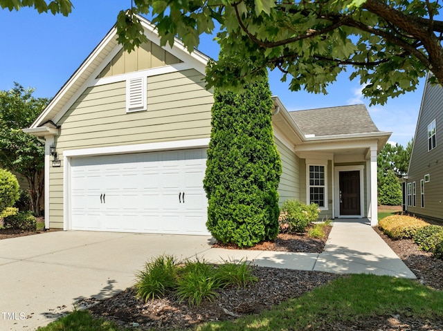 1704 Horne Creek Dr, Durham, NC 27703 - view of front facade featuring a garage, driveway, a shingled roof, and board and batten siding