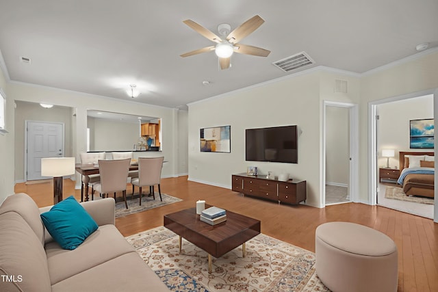 1704 Horne Creek Dr, Durham, NC 27703 - living room with light wood-type flooring, crown molding, and ceiling fan