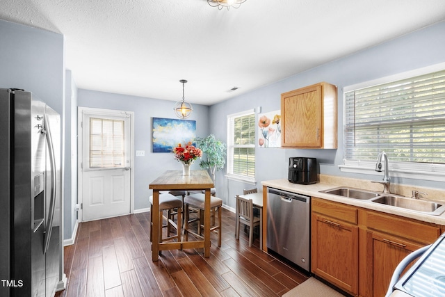 117 Gladstone Dr, Durham, NC 27703 - kitchen featuring appliances with stainless steel finishes, plenty of natural light, dark wood-style flooring, and light countertops