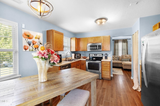 117 Gladstone Dr, Durham, NC 27703 - kitchen with stainless steel appliances, light countertops, plenty of natural light, and wood finished floors