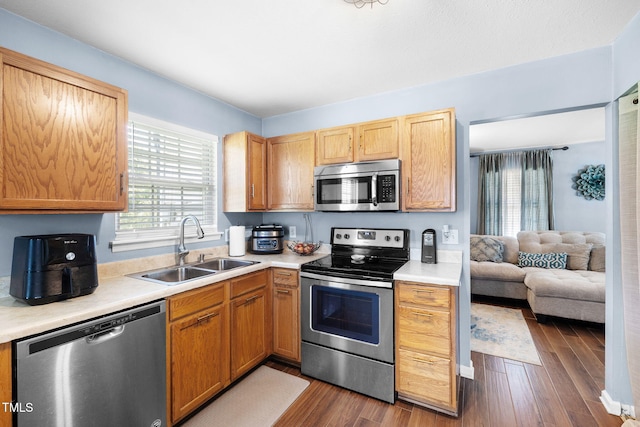 117 Gladstone Dr, Durham, NC 27703 - kitchen with stainless steel appliances, light countertops, dark wood-type flooring, and open floor plan