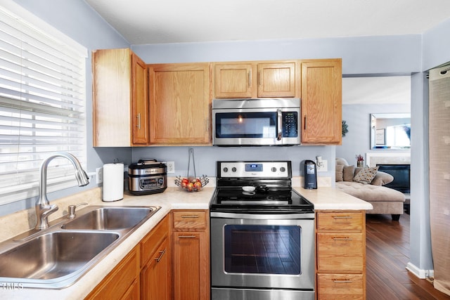 117 Gladstone Dr, Durham, NC 27703 - kitchen featuring appliances with stainless steel finishes, light countertops, and dark wood-type flooring