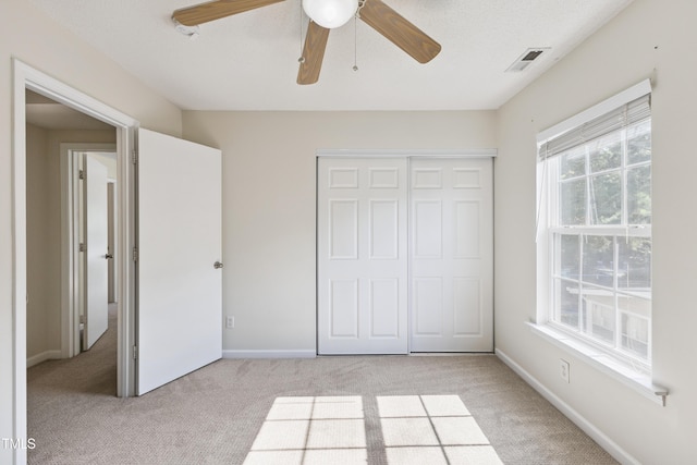 328 Palmdale Ct, Holly Springs, NC 27540 - unfurnished bedroom with light carpet, a closet, and a ceiling fan