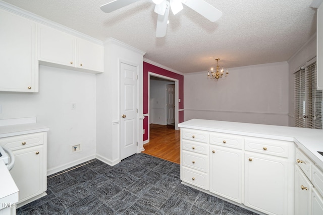 413 S Fayetteville St, Clayton, NC 27520 - kitchen with a textured ceiling, white cabinets, a chandelier, ornamental molding, and light countertops
