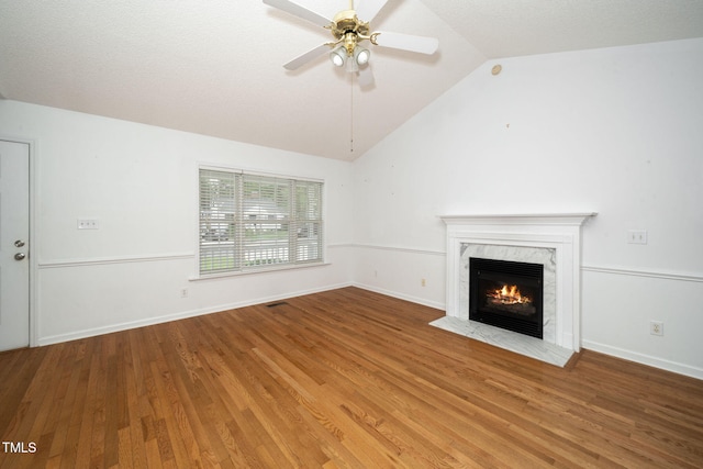 413 S Fayetteville St, Clayton, NC 27520 - unfurnished living room featuring vaulted ceiling, a ceiling fan, wood finished floors, and a premium fireplace