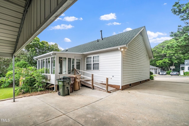 413 S Fayetteville St, Clayton, NC 27520 - back of house featuring a sunroom, roof with shingles, crawl space, and a patio