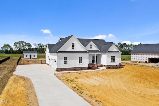 2379 Heartland Rd, Battleboro, NC 27809 - modern inspired farmhouse with crawl space, concrete driveway, roof with shingles, and an outbuilding
