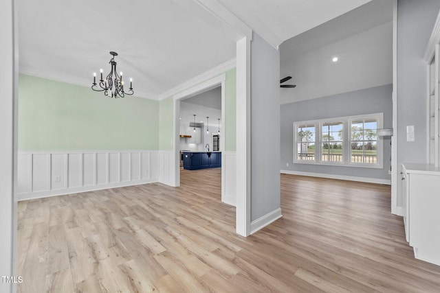 2379 Heartland Rd, Battleboro, NC 27809 - unfurnished dining area featuring a chandelier, light wood-style floors, ornamental molding, and wainscoting
