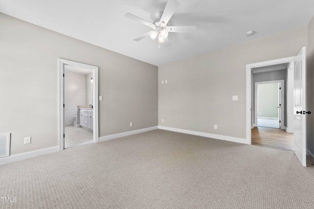 2379 Heartland Rd, Battleboro, NC 27809 - unfurnished bedroom with light carpet, ensuite bath, and a ceiling fan