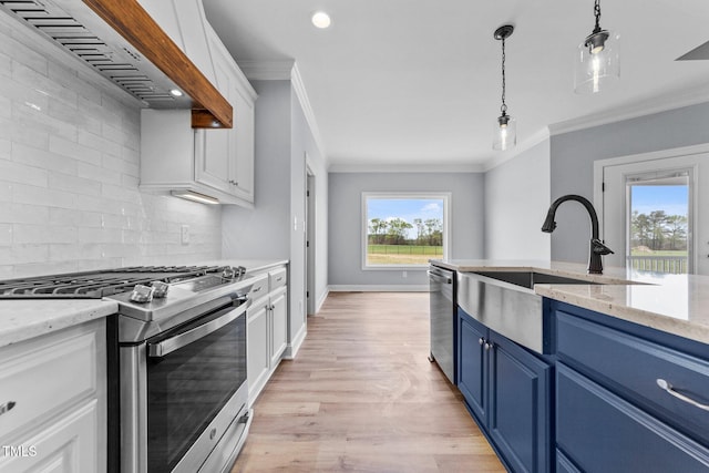 2379 Heartland Rd, Battleboro, NC 27809 - kitchen featuring stainless steel appliances, blue cabinetry, range hood, white cabinets, and crown molding