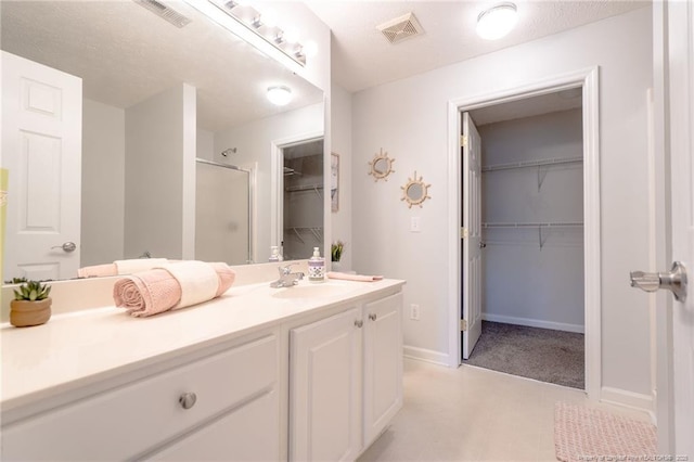 3314 Harbour Pointe Pl Unit 8, Fayetteville, NC 28314 - bathroom featuring a shower stall, a spacious closet, vanity, and tile patterned floors