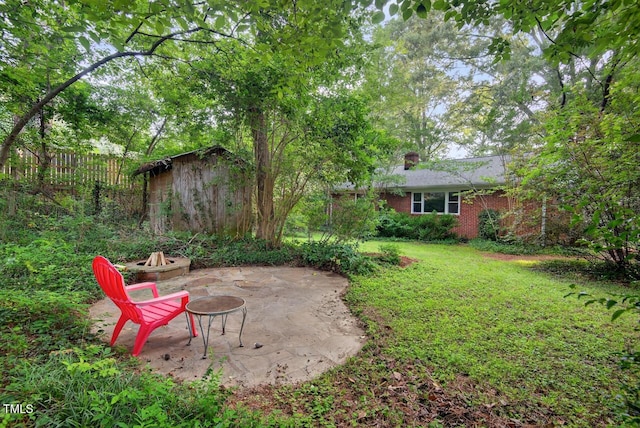 3215 Oxford Dr, Durham, NC 27707 - view of yard featuring an outdoor fire pit, a patio area, and a shed
