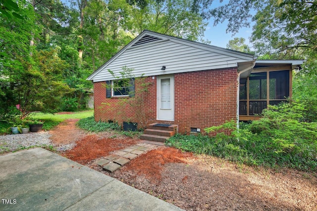 3215 Oxford Dr, Durham, NC 27707 - view of front of house featuring a sunroom and brick siding