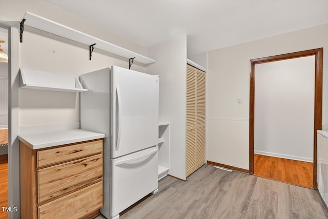 3215 Oxford Dr, Durham, NC 27707 - kitchen with freestanding refrigerator, light wood-style flooring, and light countertops