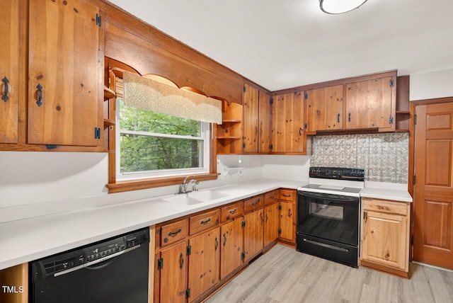 3215 Oxford Dr, Durham, NC 27707 - kitchen with electric range oven, black dishwasher, light wood-style flooring, tasteful backsplash, and light countertops