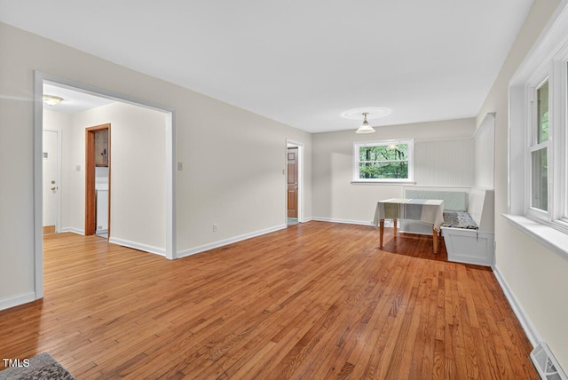 3215 Oxford Dr, Durham, NC 27707 - unfurnished living room with light wood-style flooring and baseboards