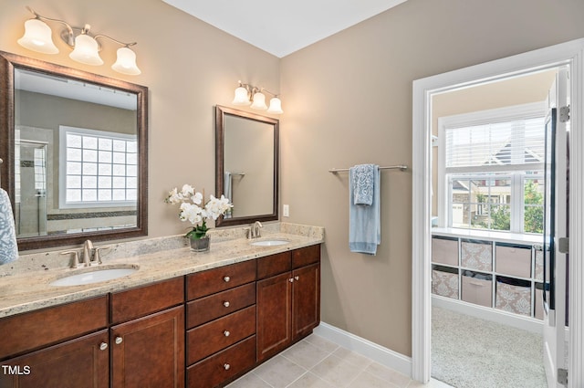 2712 Lake Waccamaw Trl, Apex, NC 27502 - full bath with healthy amount of natural light, double vanity, a stall shower, and tile patterned floors