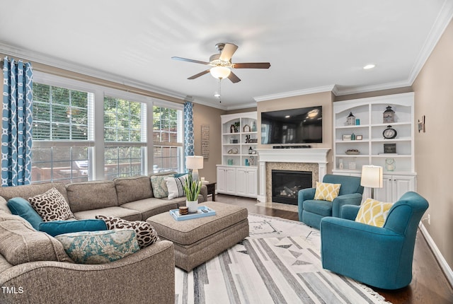 2712 Lake Waccamaw Trl, Apex, NC 27502 - living area featuring wood finished floors, a ceiling fan, ornamental molding, a fireplace with flush hearth, and recessed lighting
