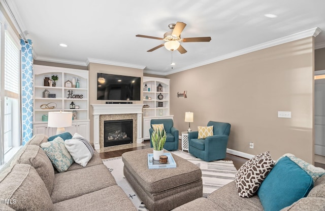 2712 Lake Waccamaw Trl, Apex, NC 27502 - living area featuring wood finished floors, ceiling fan, crown molding, a fireplace with flush hearth, and recessed lighting