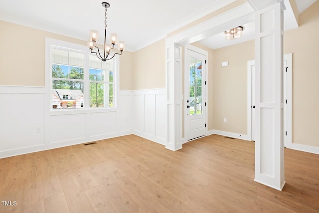 140 Purslane Dr, Franklinton, NC 27525 - foyer entrance with a chandelier, light wood-style floors, a wainscoted wall, and a decorative wall