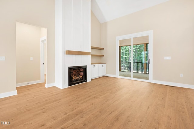 140 Purslane Dr, Franklinton, NC 27525 - unfurnished living room featuring high vaulted ceiling, light wood-type flooring, and a fireplace