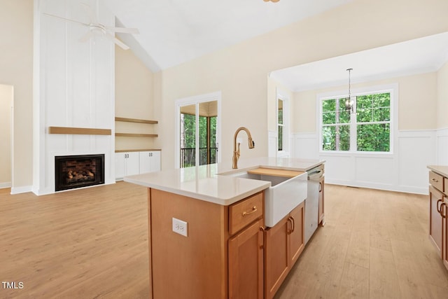 140 Purslane Dr, Franklinton, NC 27525 - kitchen with dishwasher, light wood-type flooring, a wainscoted wall, light countertops, and brown cabinets