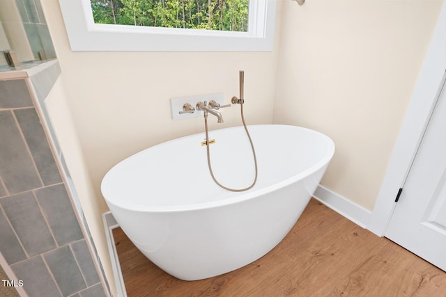 140 Purslane Dr, Franklinton, NC 27525 - full bath with wood finished floors and a freestanding tub