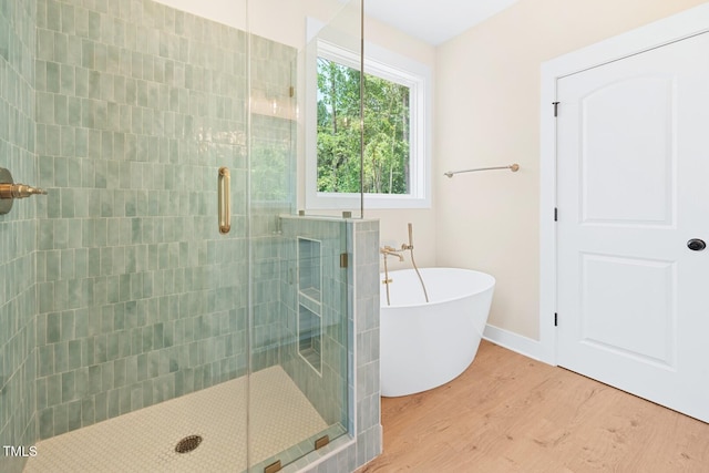 140 Purslane Dr, Franklinton, NC 27525 - bathroom featuring wood finished floors, a stall shower, and a freestanding bath