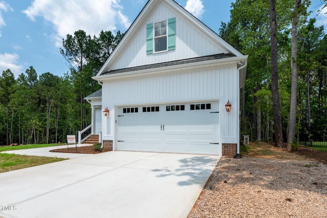 140 Purslane Dr, Franklinton, NC 27525 - view of side of property featuring concrete driveway, a shingled roof, and board and batten siding