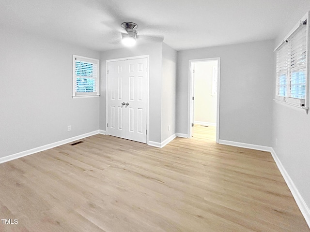 845 Newcombe Rd, Raleigh, NC 27610 - unfurnished bedroom featuring light wood-style flooring, a closet, and a ceiling fan