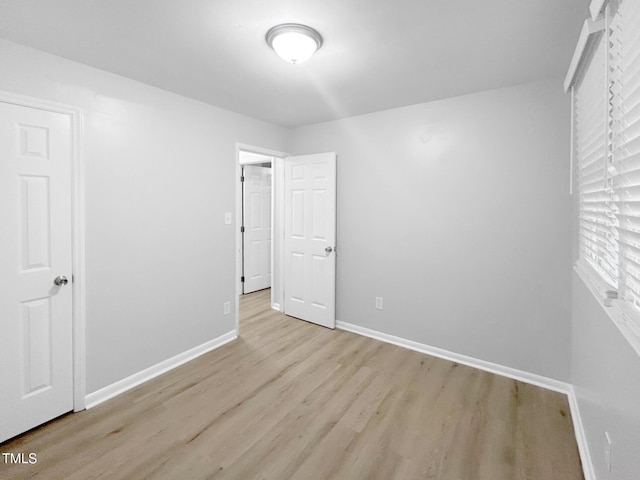 845 Newcombe Rd, Raleigh, NC 27610 - unfurnished bedroom featuring light wood-style flooring and baseboards