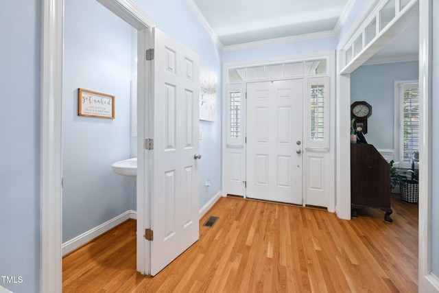 1824 Ferrell Meadows Dr, Zebulon, NC 27597 - foyer with light wood finished floors and ornamental molding