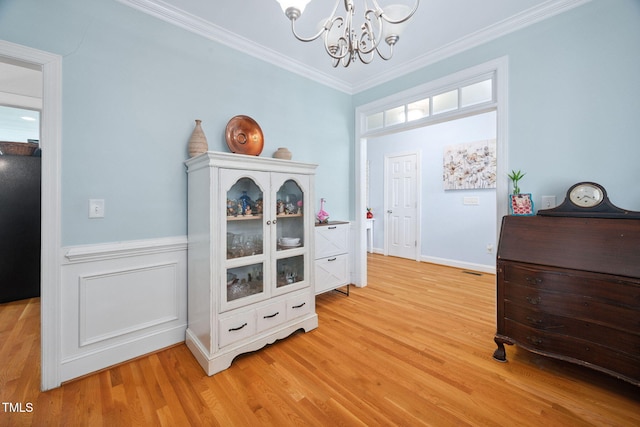 1824 Ferrell Meadows Dr, Zebulon, NC 27597 - foyer with a chandelier, ornamental molding, and light wood finished floors