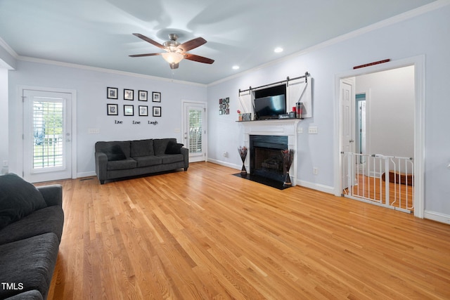 1824 Ferrell Meadows Dr, Zebulon, NC 27597 - living area with ceiling fan, ornamental molding, light wood-type flooring, recessed lighting, and a fireplace with flush hearth