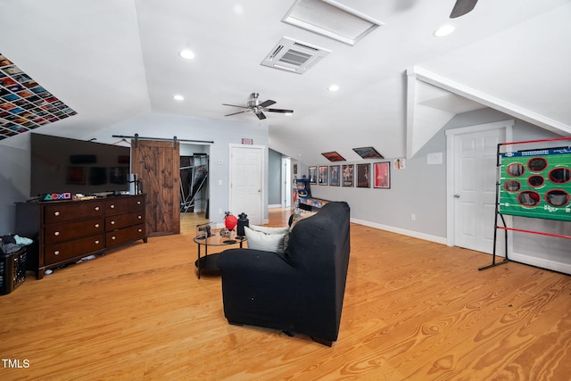 1824 Ferrell Meadows Dr, Zebulon, NC 27597 - living room with a ceiling fan, light wood-type flooring, vaulted ceiling, a barn door, and attic access