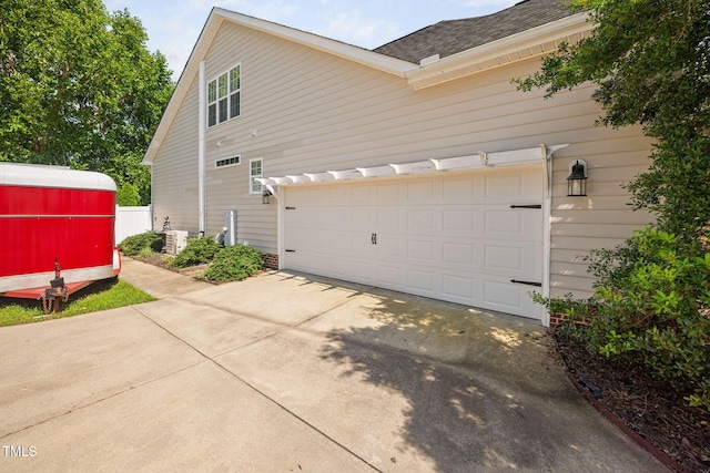 1824 Ferrell Meadows Dr, Zebulon, NC 27597 - view of side of property with concrete driveway, a shingled roof, and an attached garage