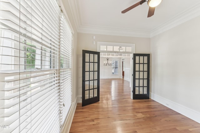 528 Bankhead Dr, Cary, NC 27519 - hallway with french doors, crown molding, a chandelier, and light wood-style floors