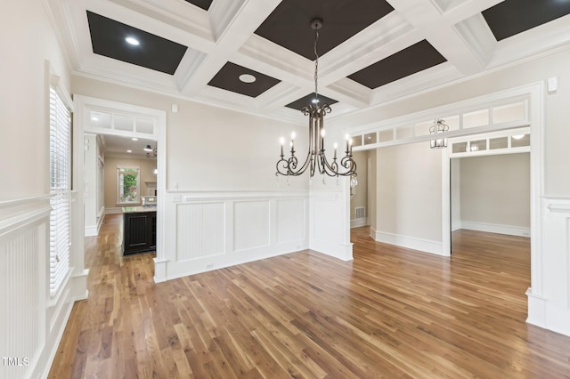 528 Bankhead Dr, Cary, NC 27519 - unfurnished dining area featuring light wood-style floors, coffered ceiling, a chandelier, beamed ceiling, and crown molding