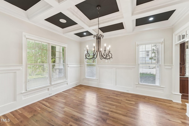 528 Bankhead Dr, Cary, NC 27519 - unfurnished dining area featuring coffered ceiling, beamed ceiling, a decorative wall, wood finished floors, and a chandelier