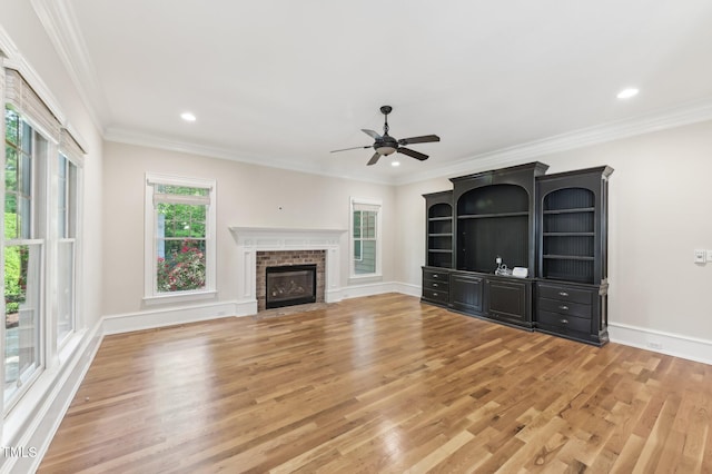 528 Bankhead Dr, Cary, NC 27519 - unfurnished living room with light wood finished floors, a ceiling fan, a fireplace, ornamental molding, and recessed lighting